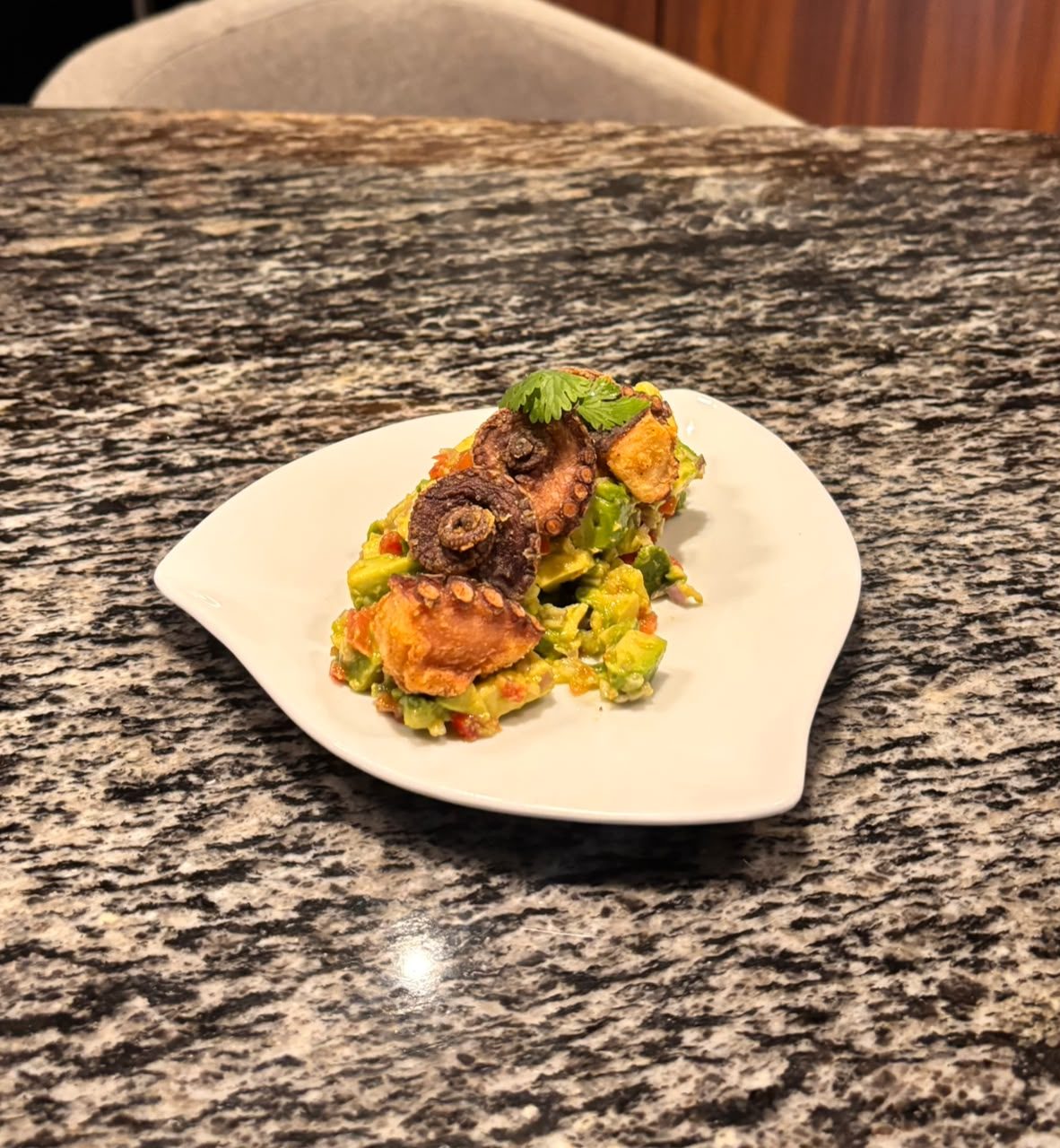 Crispy fried octopus over guacamole